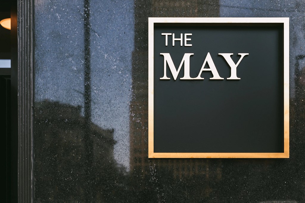 The May, exterior signage in gold.