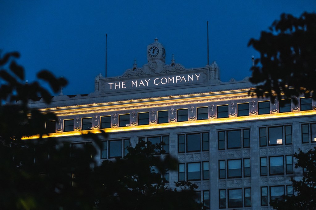 Exterior signage at The May at night.