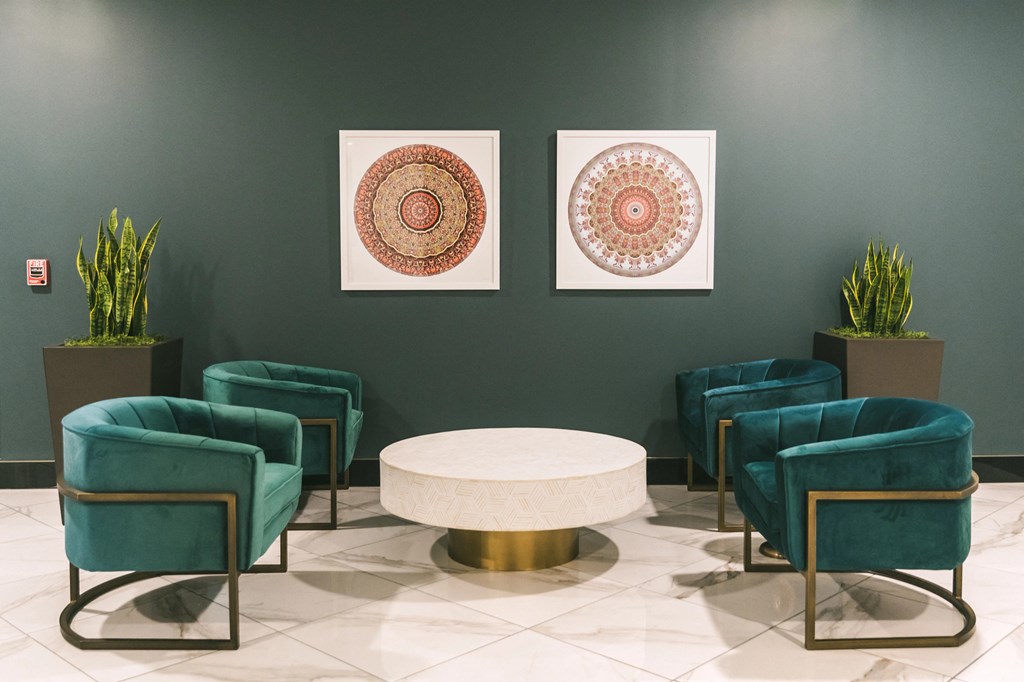 Interior lounge area with elegant furnishings and art work at The May.