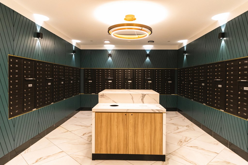 Mail room with forest green walls and private mailboxes at The May.