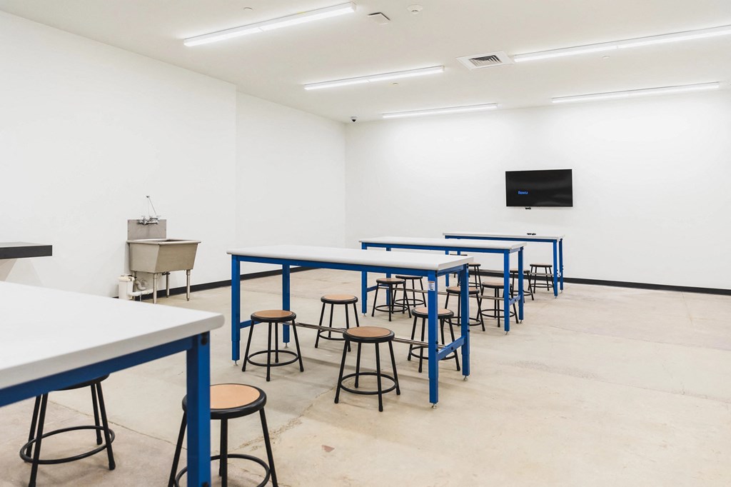 Community art and maker space with wash sink and working tables at The May.