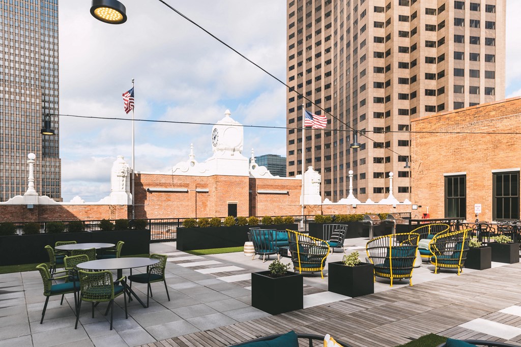 Residential rooftop lounge with a variety of seating and a view of downtown Cleveland.