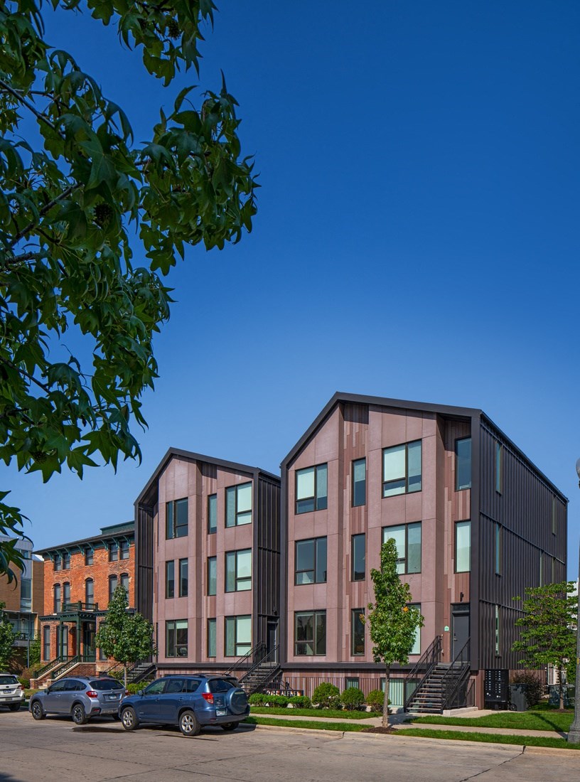 a group of buildings with cars parked in front of them