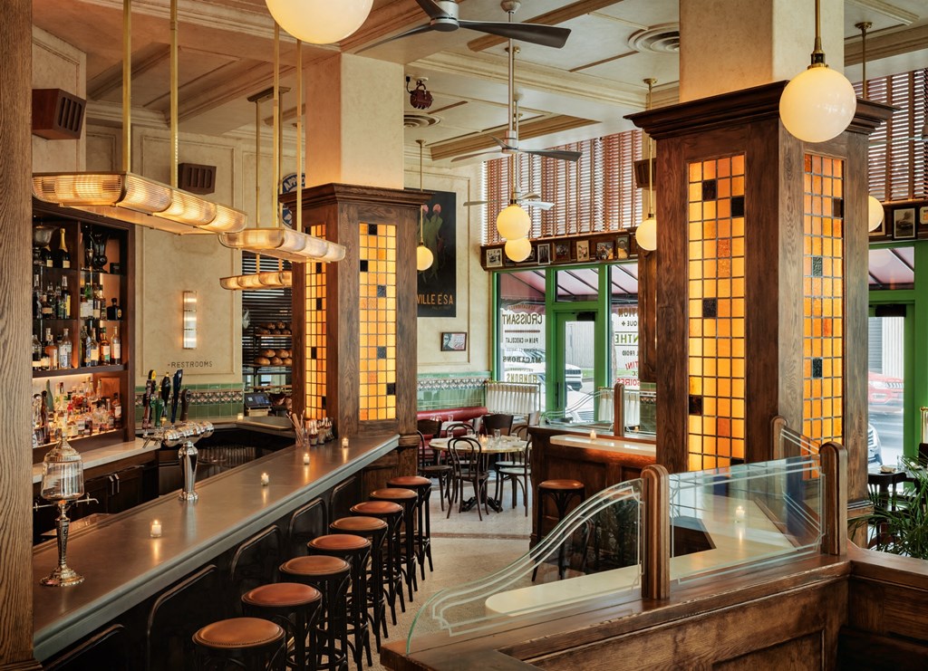 a bar in a restaurant with wooden pillars and chairsat Book Tower, Detroit, 48226