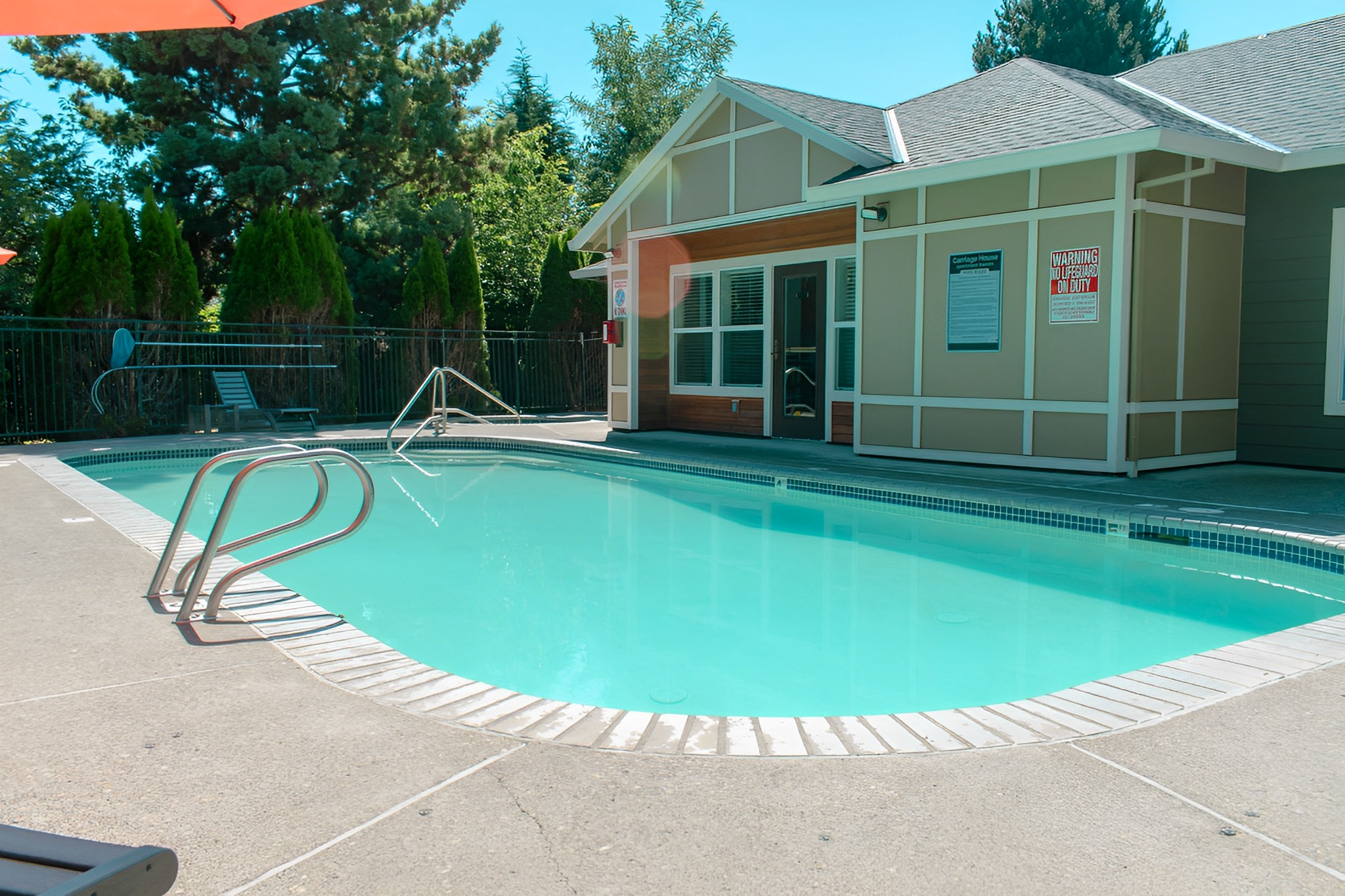 A pool with a building next to it.