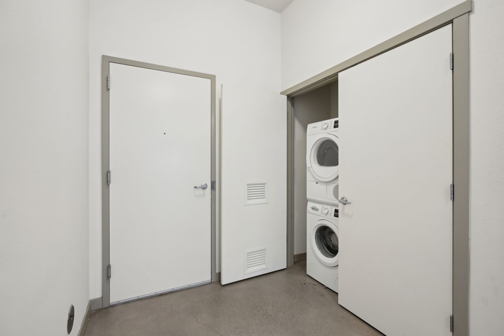 A laundry room with a washer and dryer in it.