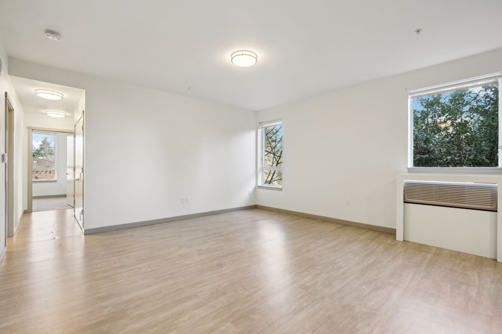 A room with wooden floors and white walls.