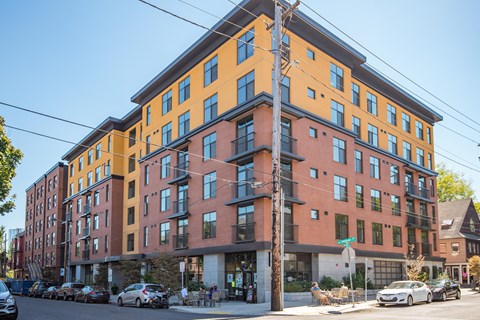 A multi-story building with a mix of orange and red facades.