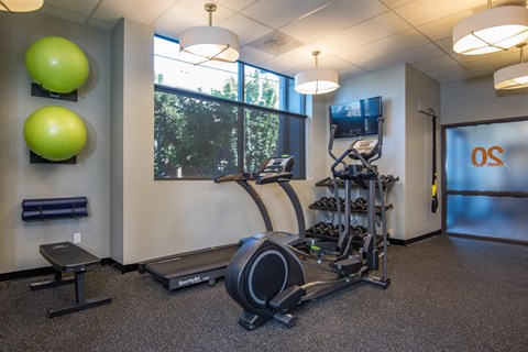 a gym with exercise equipment and a window