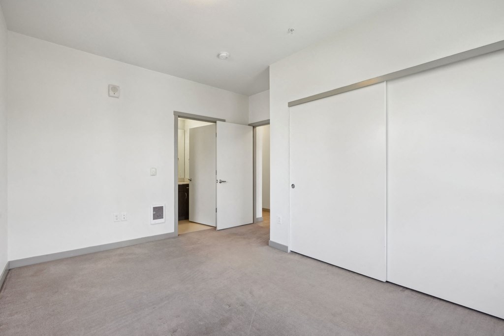 A room with white walls and a grey floor.