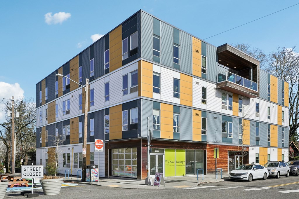 A street view of a multi-story building with a