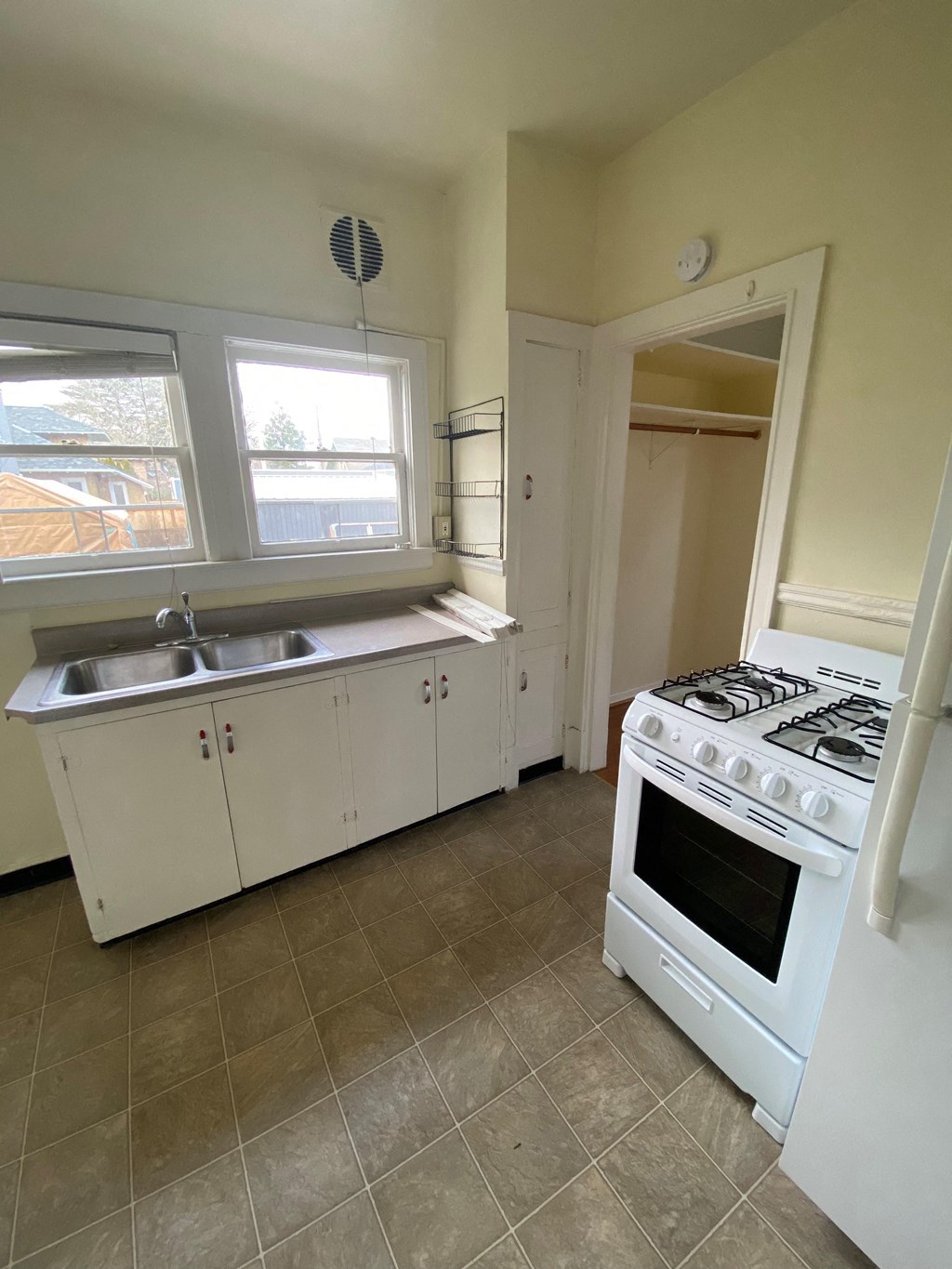 a kitchen with a stove a sink and a window