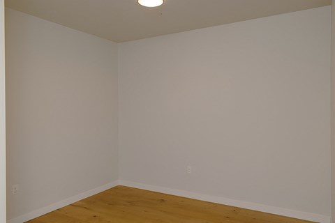 A room with a wooden floor and white walls.