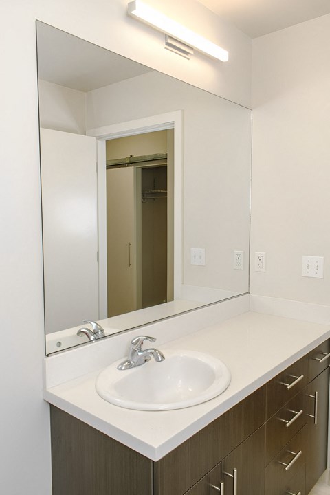 A bathroom with a sink and mirror.
