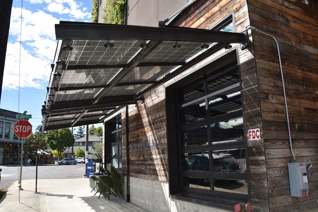 awning over the front of a building with a stop sign