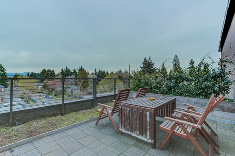 a patio with a table and chairs on a balcony