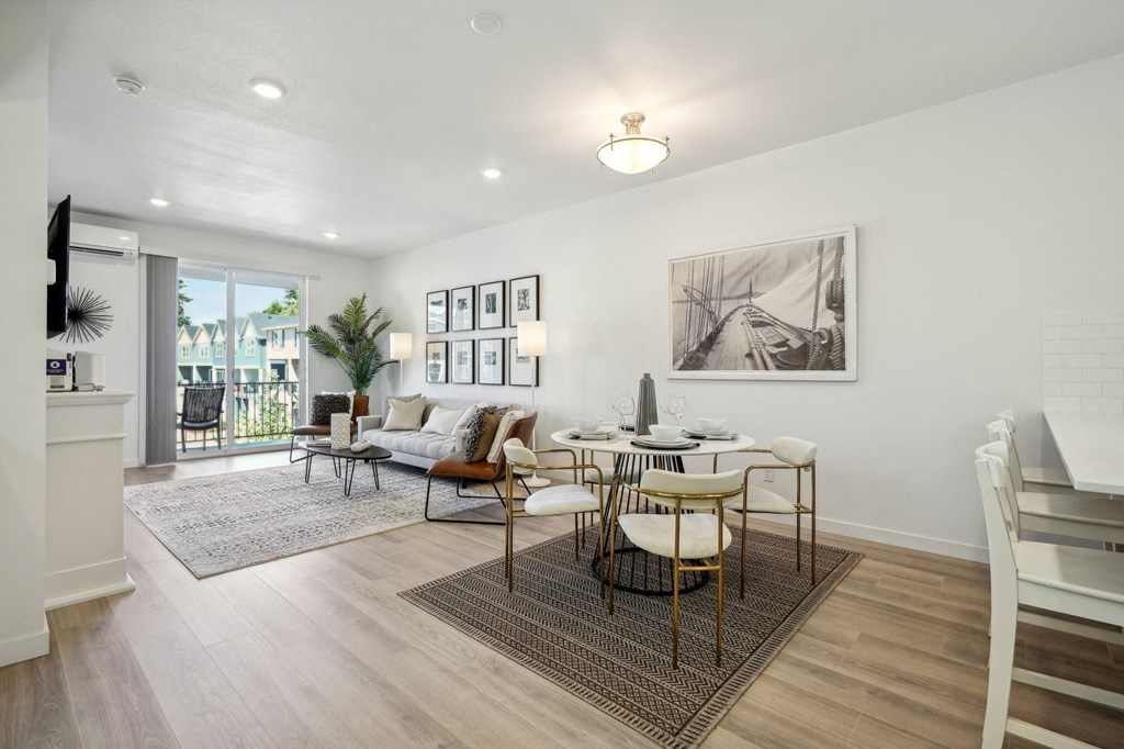 an open living room and dining room with a table and chairs