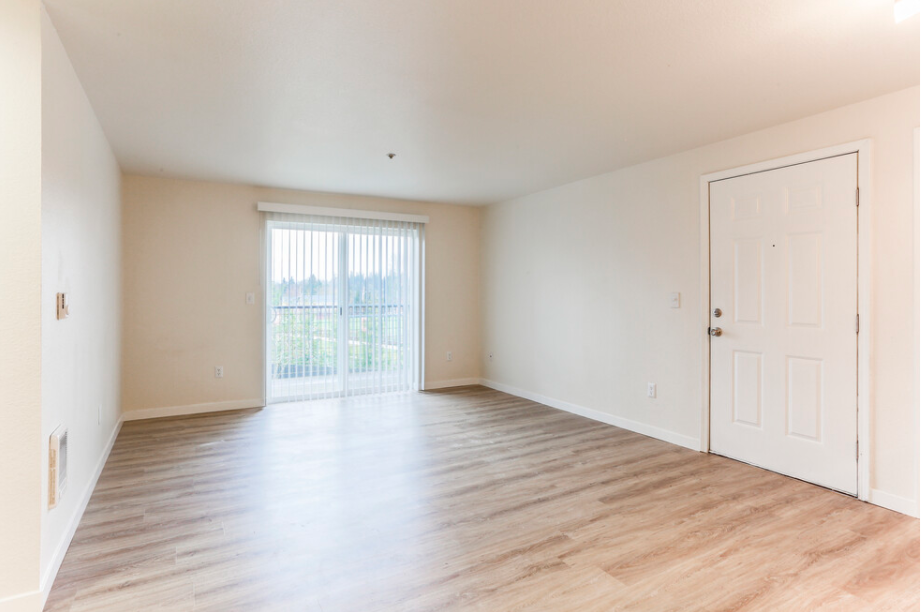 Empty room with wooden floor and white walls.