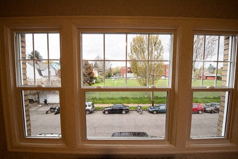 A view from a window looking out at a parking lot.