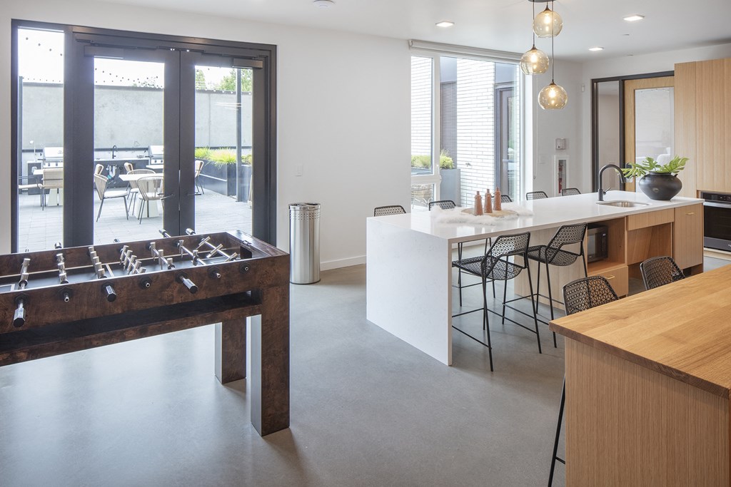 a foosball table in the center of a kitchen with a bar and a at The Weidler in Portland, OR 97209