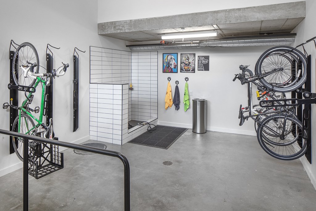 a room with bikes hanging on the wall and a bike rack in the corner at The Weidler in Portland, OR 97209