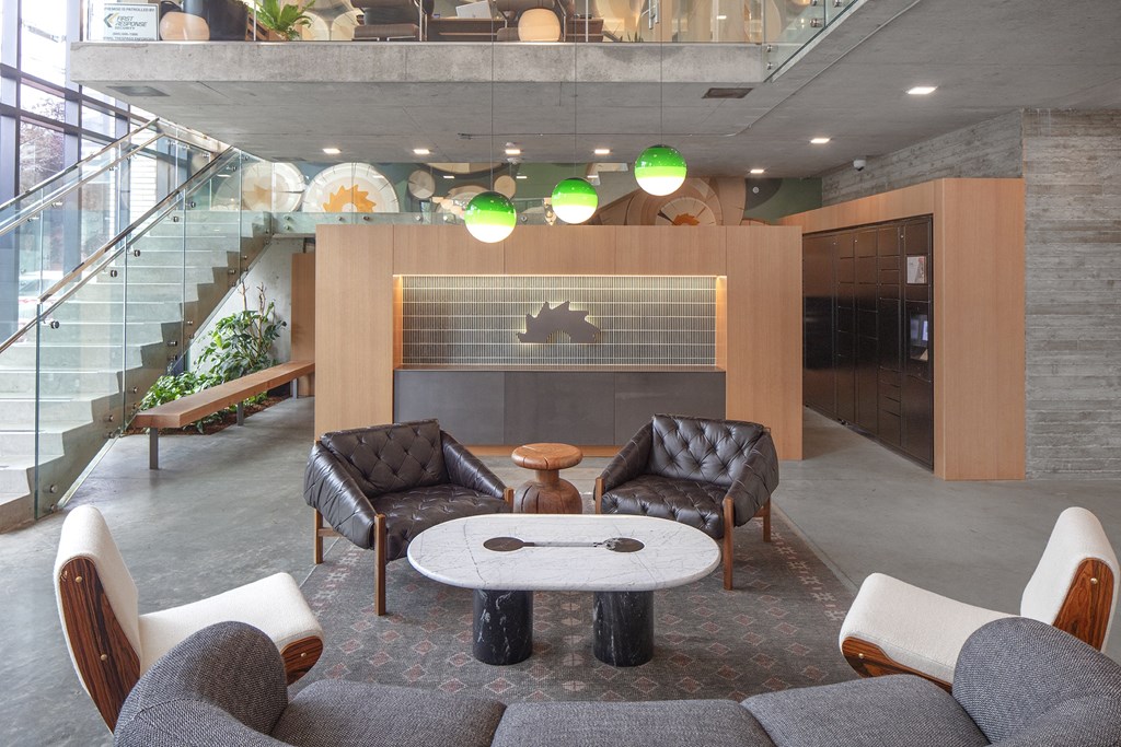 a living room with two chairs and a table in front of a fireplace at The Weidler in Portland, OR 97209
