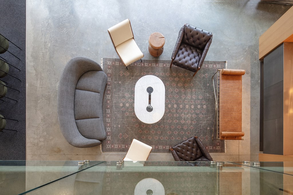 a living room with chairs and a clock on the floor at The Weidler in Portland, OR 97209
