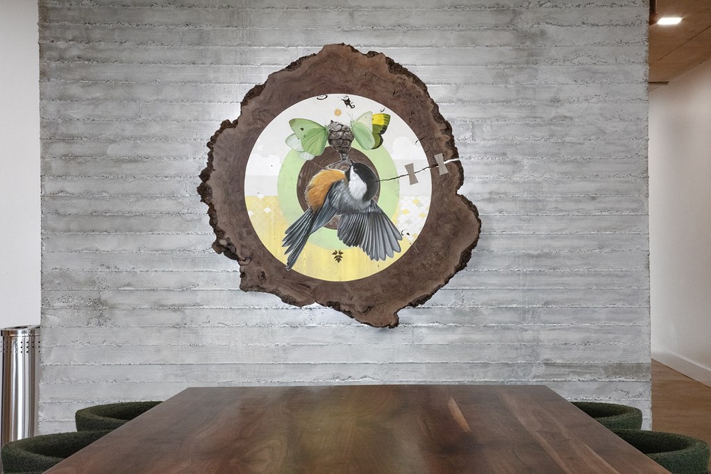 a wood wall with a bird on it and a wooden table at The Weidler in Portland, OR 97209