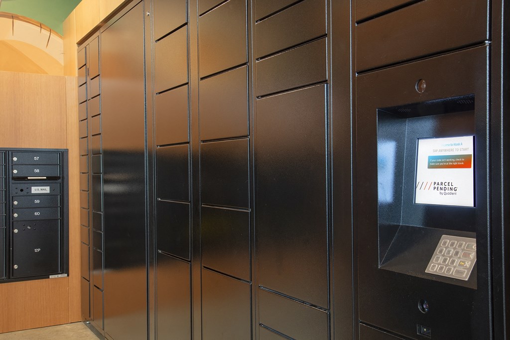 a set of stainless steel lockers with a bank teller machine in a lobby at The Weidler in Portland, OR 97209
