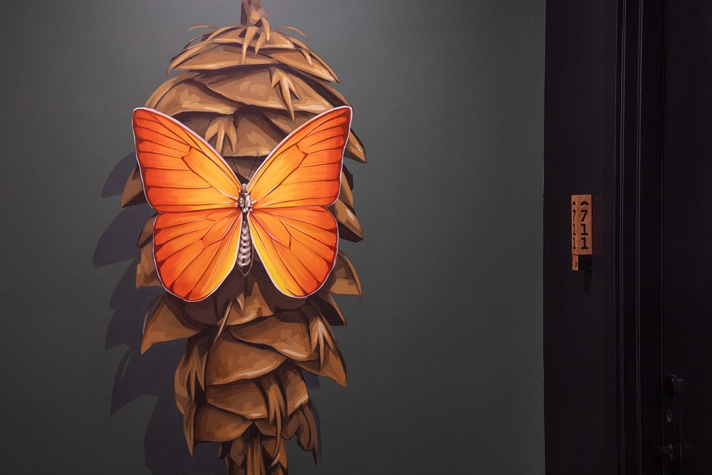 a butterfly shaped lamp on a wall next to a door at The Weidler in Portland, OR 97209