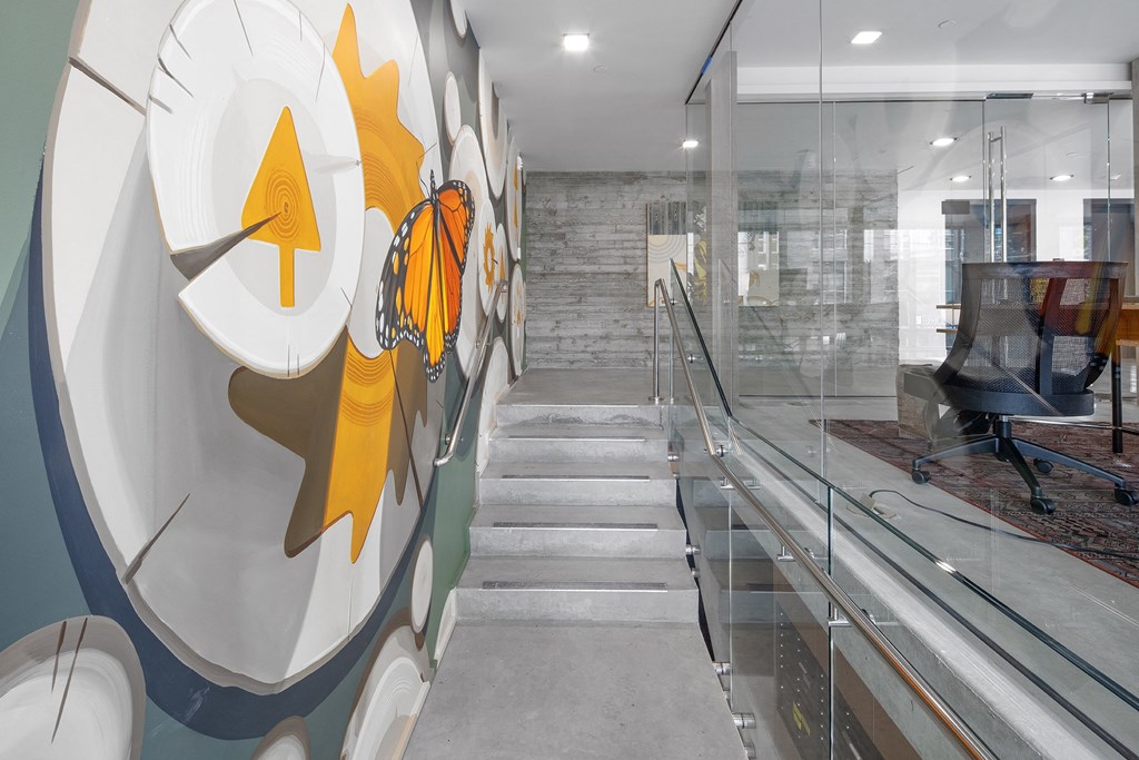 a staircase with a glass wall with a design on it at The Weidler in Portland, OR 97209