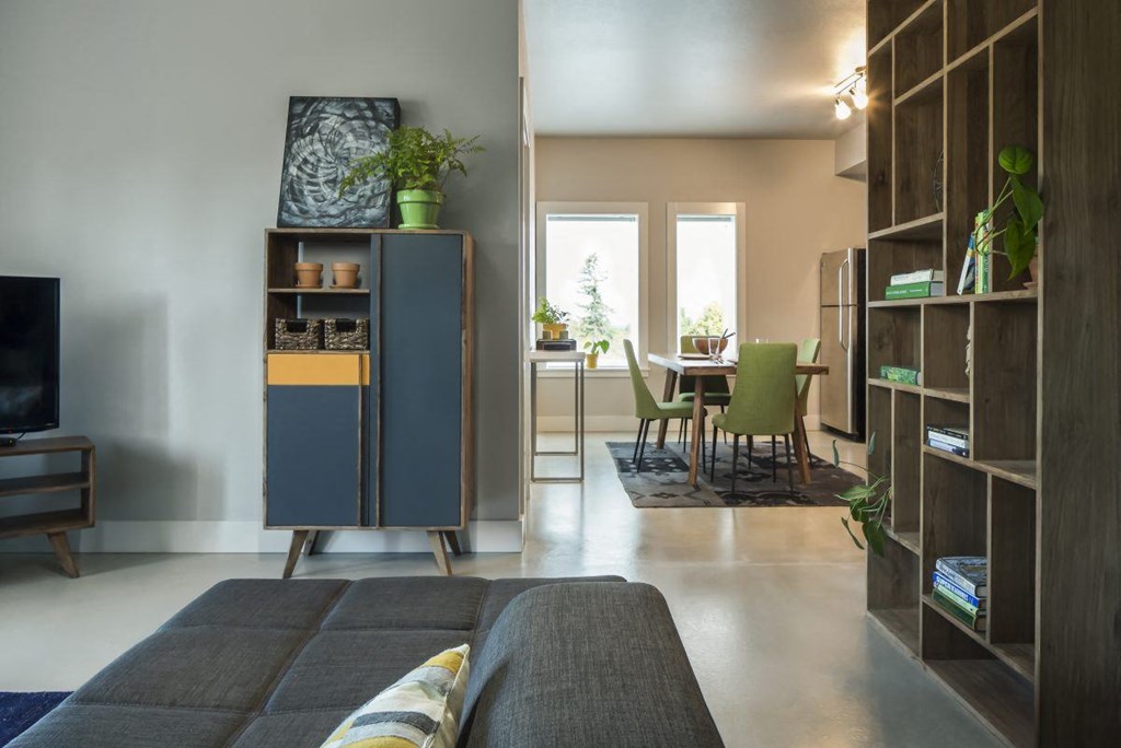 a living room with a couch and a dining room