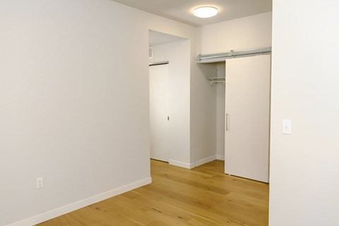 A room with a white wall and a wooden floor.