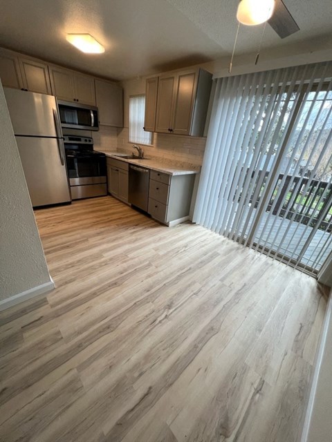 an empty kitchen with a sliding glass door