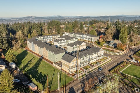 Aerial view of townhome community with surrounding trees at Holmes Park Townhomes Apartments, Oregon City, OR 97045
