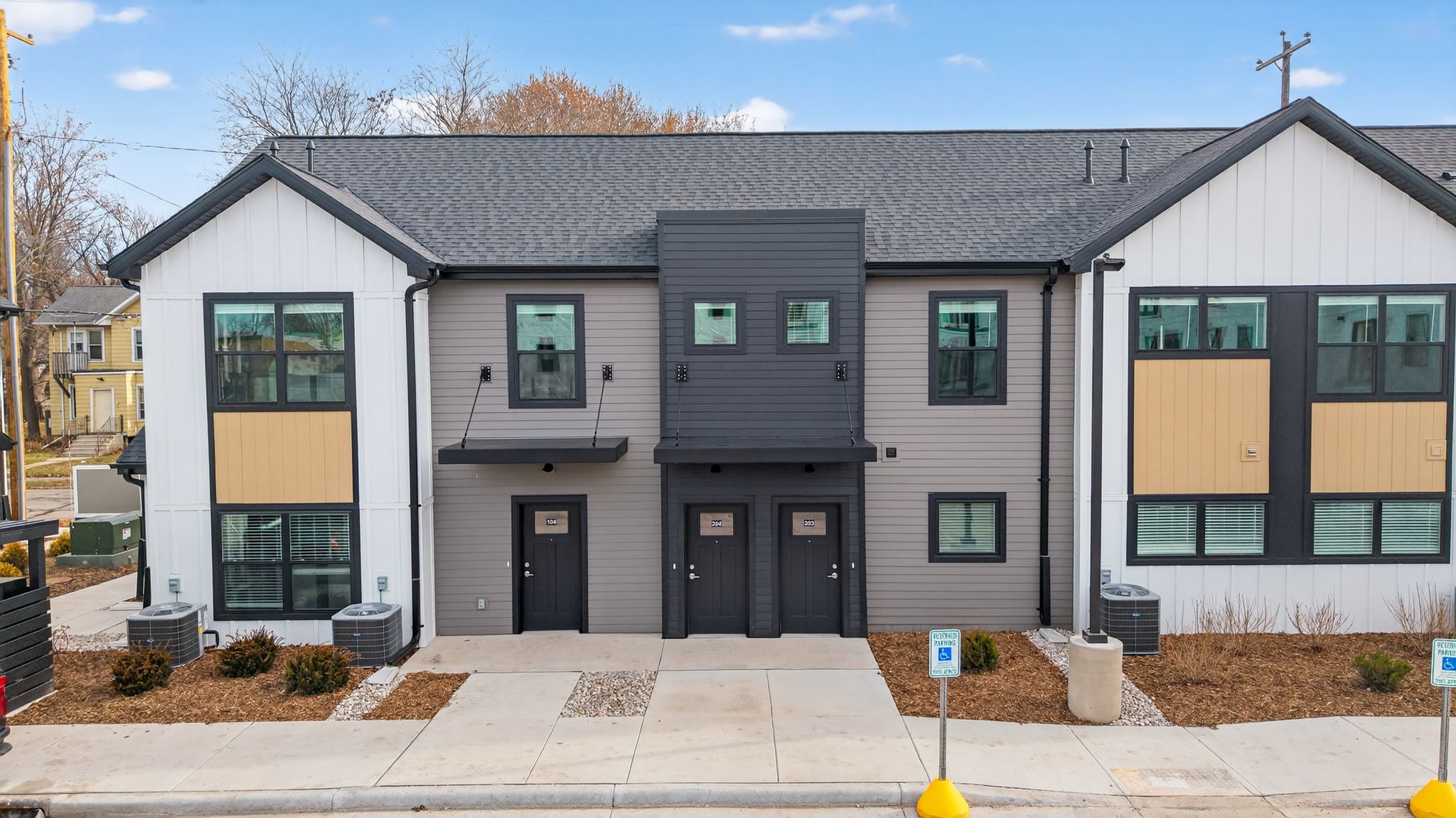 A modern two-story house with a grey and white exterior.