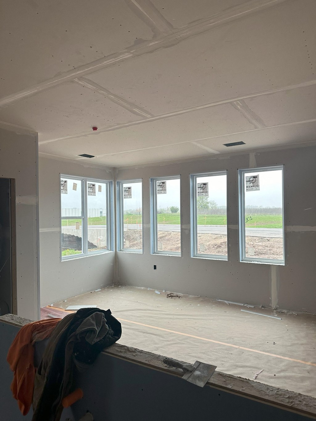 a view of the living room of a house under construction with windows