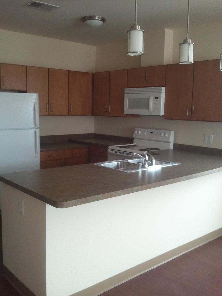 Interior a kitchen with a counter top and a refrigerator