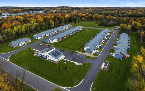 A large building complex surrounded by trees in autumn.