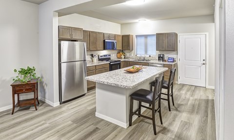 A kitchen with a table and chairs in the middle of the room.