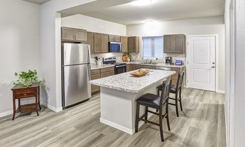 A kitchen with a table and chairs in the middle of the room.