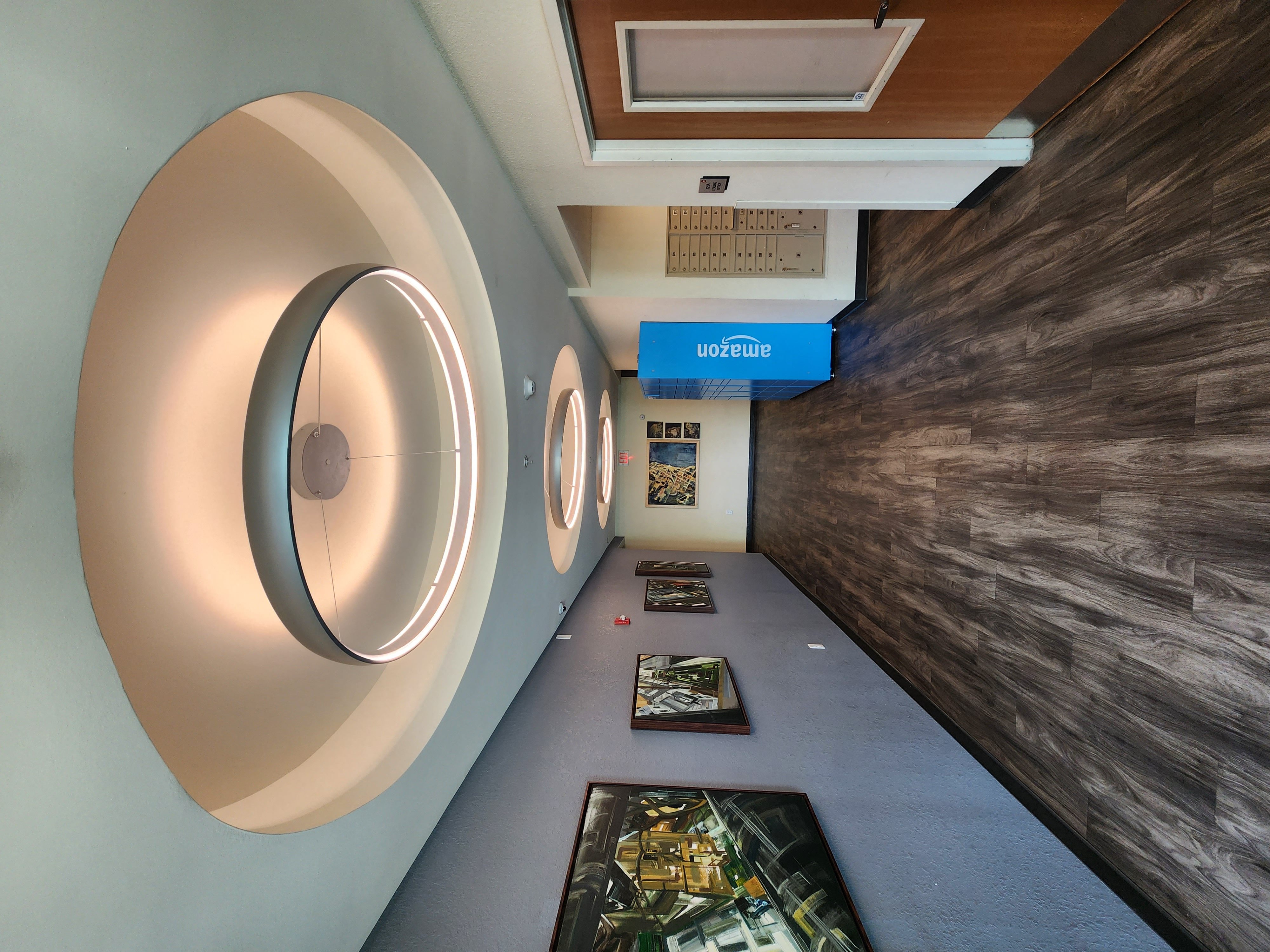 a modern hospital room with a patient exam room and a round mirror on the wall
