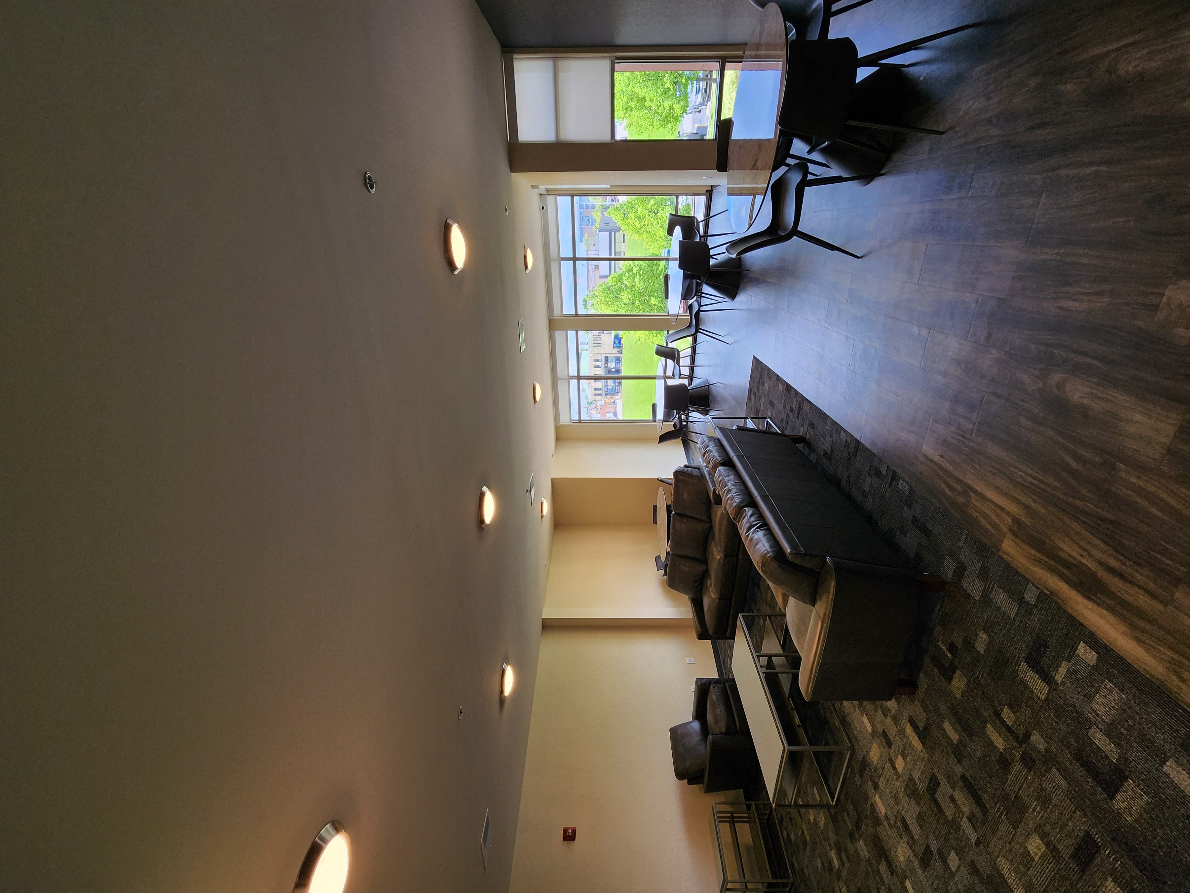an aerial view of a room with a piano and a dining room table