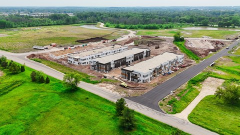 an aerial view of a building site with houses and a road
