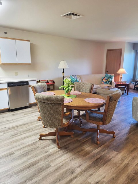 A dining room with a table and chairs.
