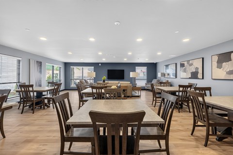 A large dining room with wooden chairs and tables.
