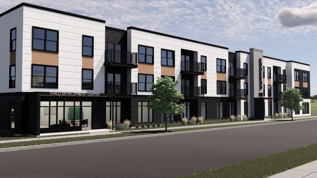 A row of modern townhouses with balconies and black railings.