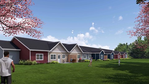 A row of houses with a man standing in front of the first house.