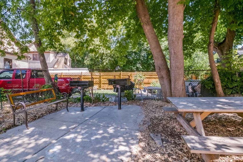 Exterior a picnic area with picnic tables and a grill