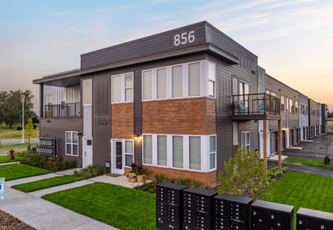 Contemporary multifamily building with balconies and mixed siding at The Daniels 1 and 2 Apartments, Saukville, WI 53080